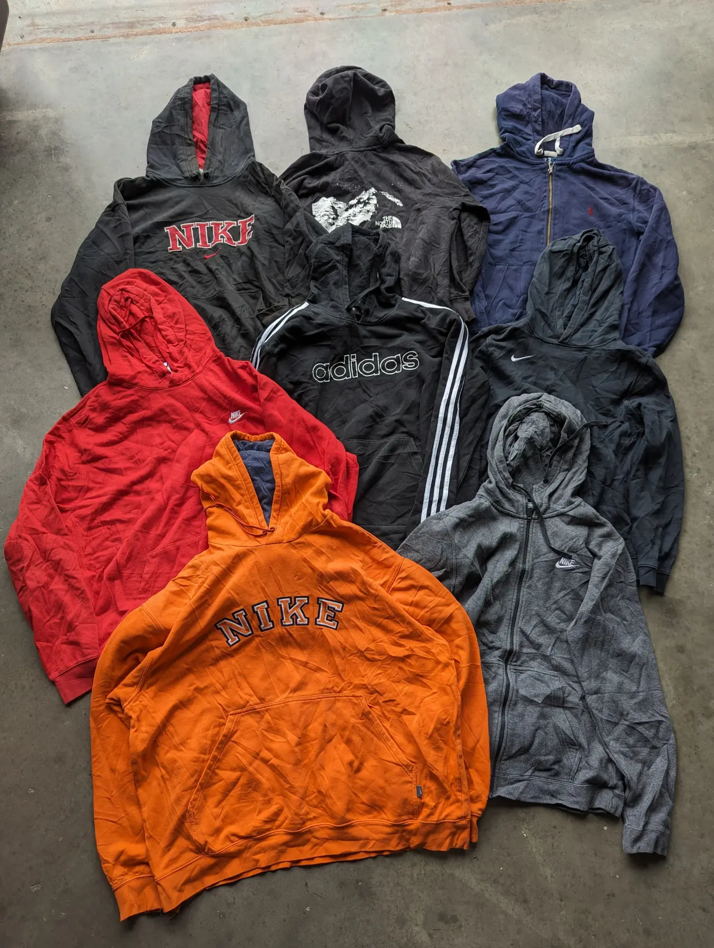 Pile of vintage hoodies and sweatshirts marked down in the WTC sale